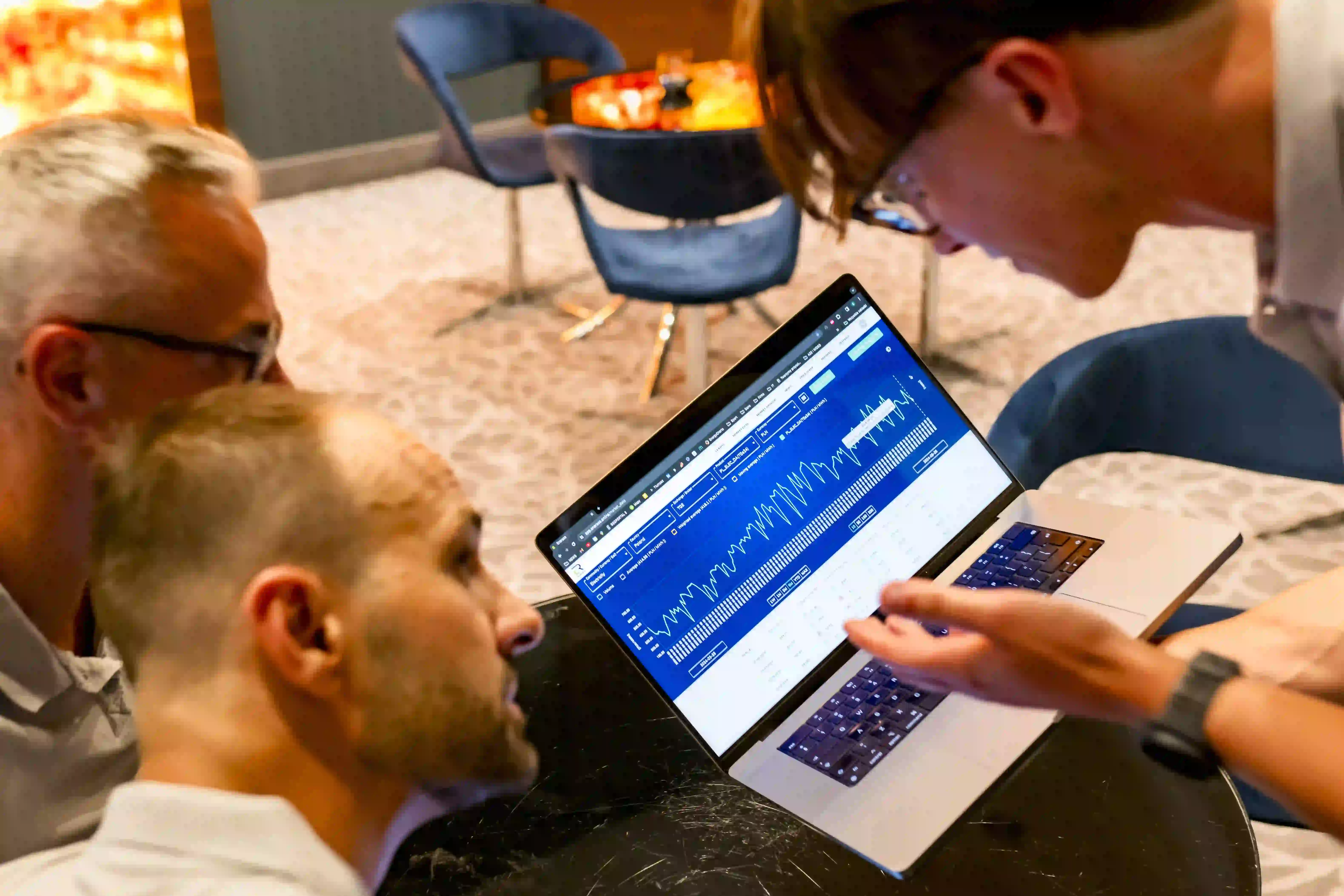 a group of people looking at a laptop